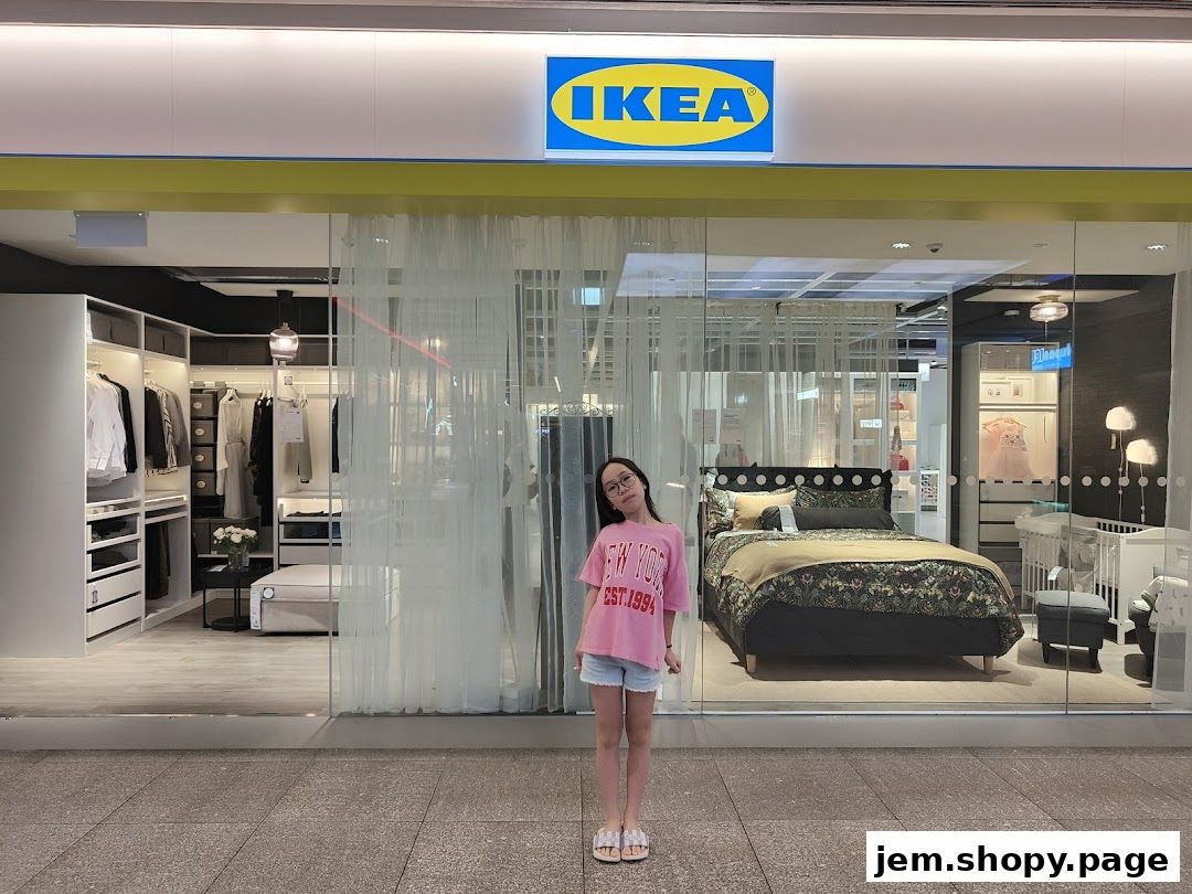 A young girl stands in front of the IKEA store entrance, showcasing bedroom and closet displays.