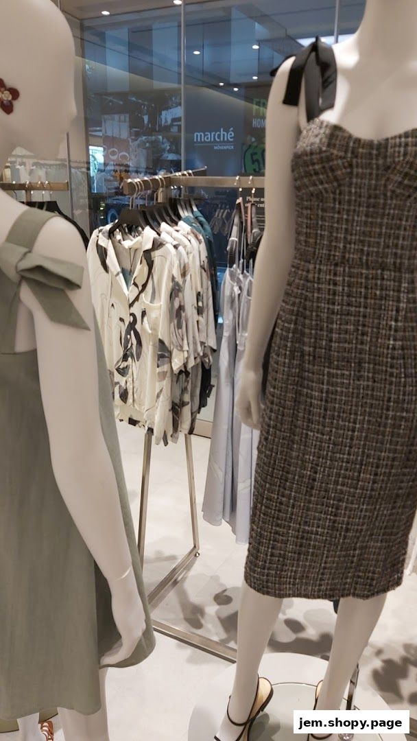 Mannequins display stylish women's fashion clothing inside a boutique.