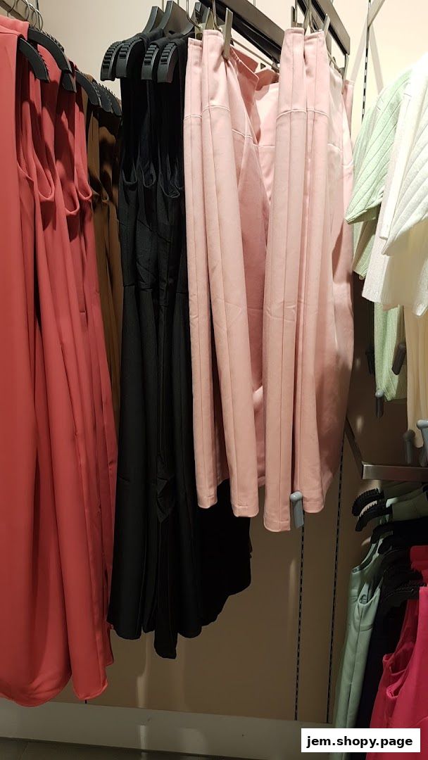 A selection of women's clothing in various colors hanging on display racks.