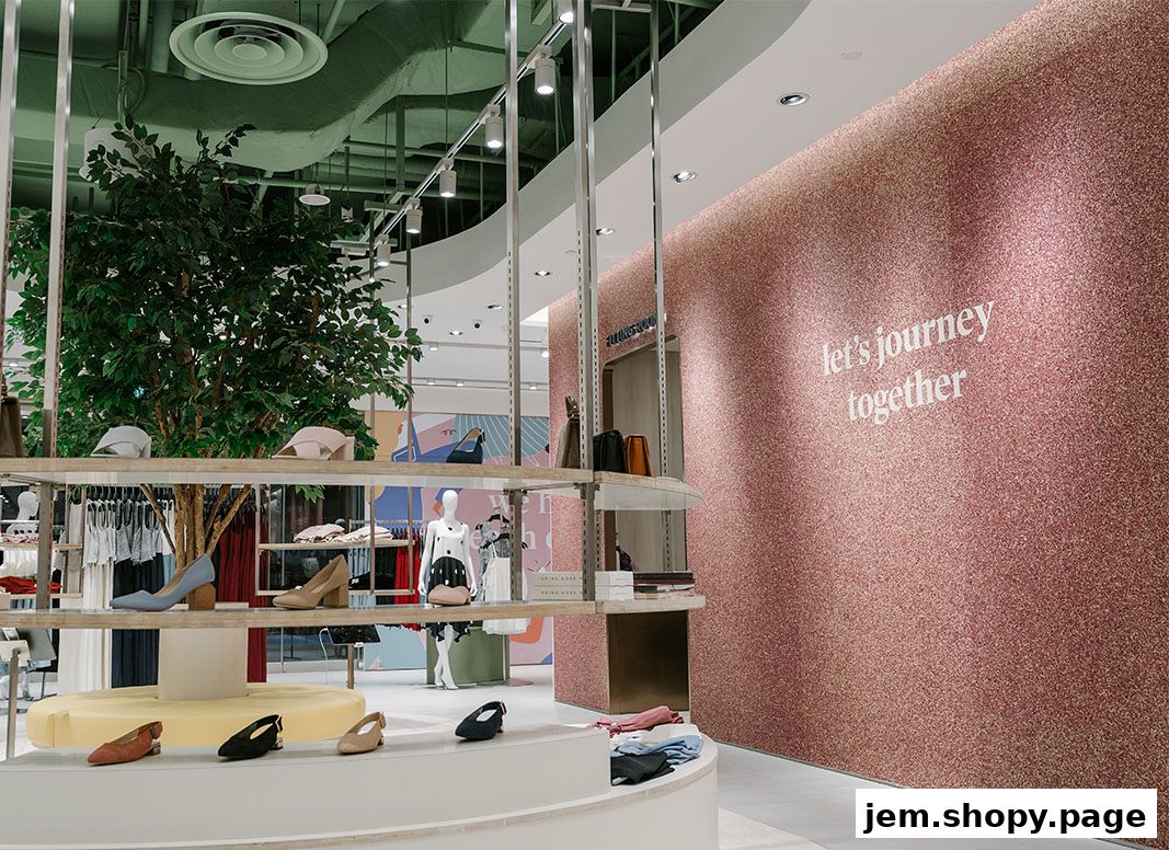 Interior view of a women's fashion store with clothing, shoes, and a decorative wall.