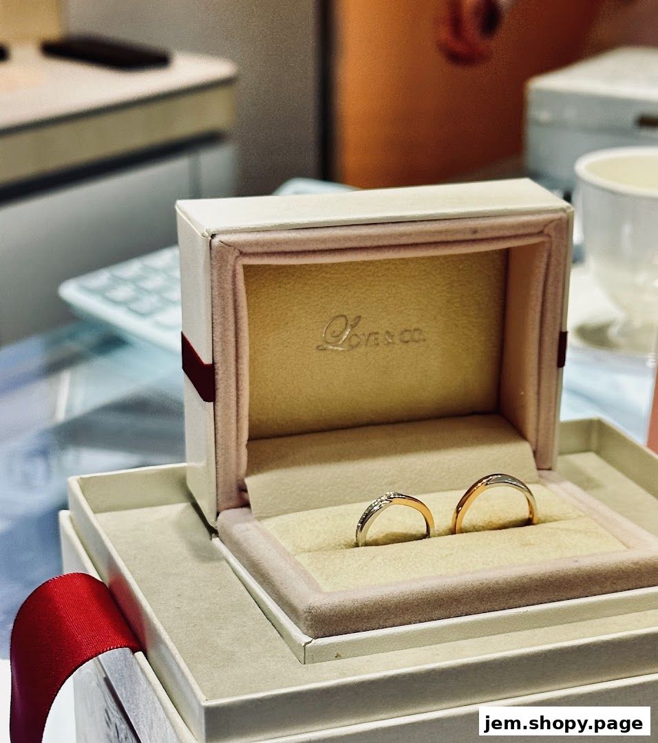 A jewelry box displays two elegant wedding bands, one with diamonds, from Love & Co.