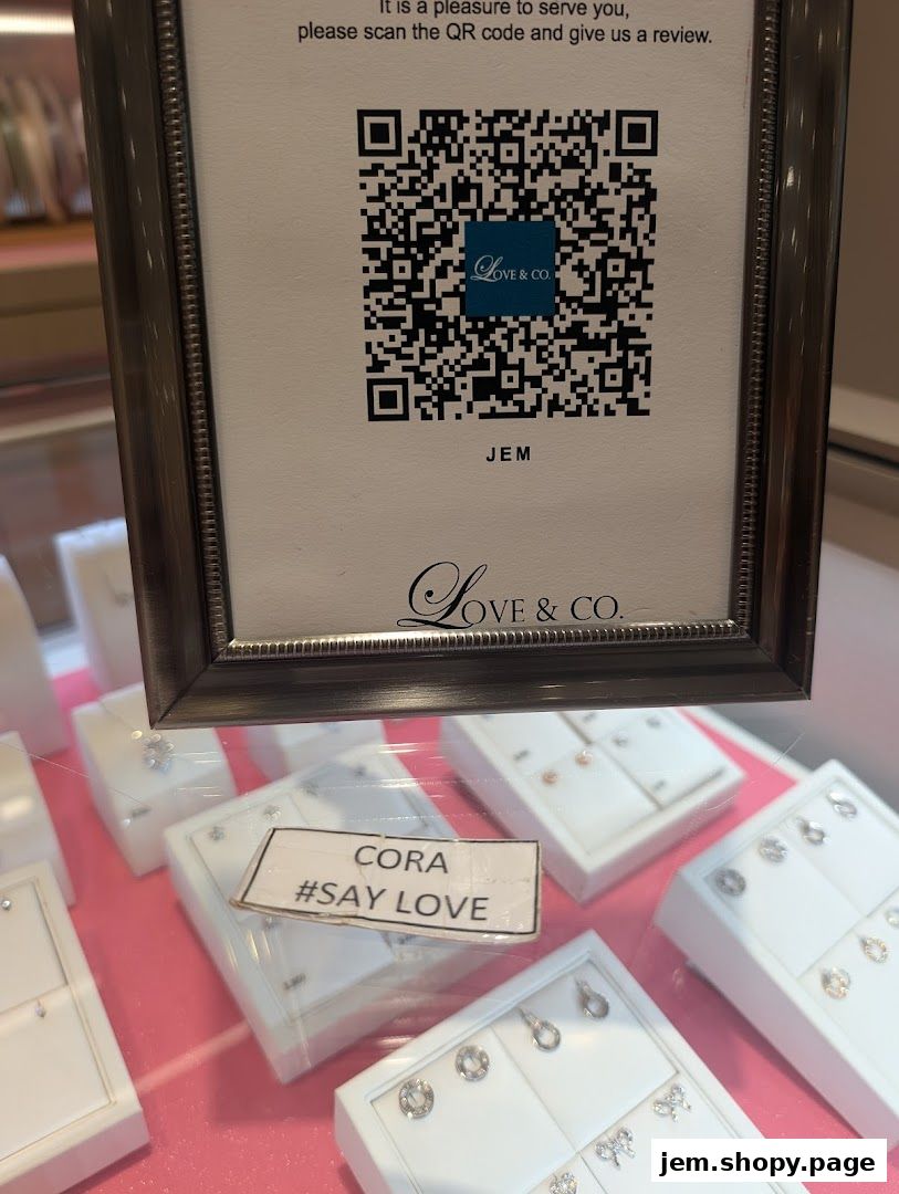 A display case filled with diamond jewelry, featuring a QR code for reviews.