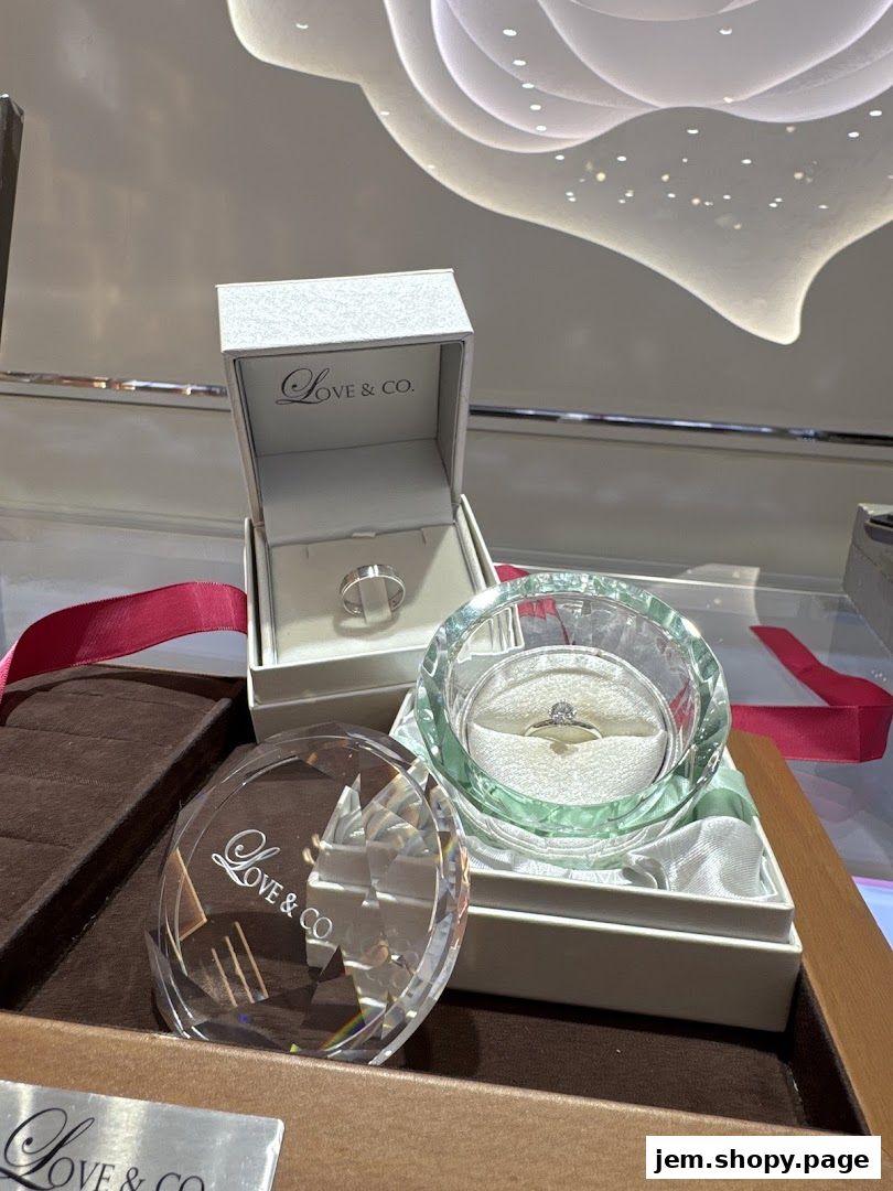 Display of engagement and wedding rings in elegant boxes and crystal holders.