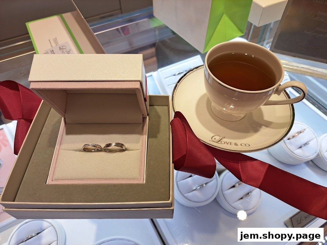 A display case featuring engagement rings and wedding bands with a cup of tea.