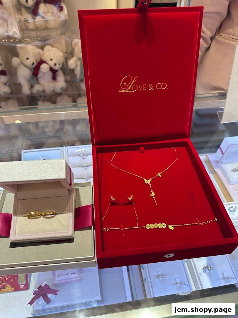 A display of elegant gold jewelry, including wedding rings and a necklace set.
