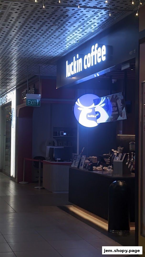 The exterior of a Luckin Coffee shop with its illuminated sign and logo.