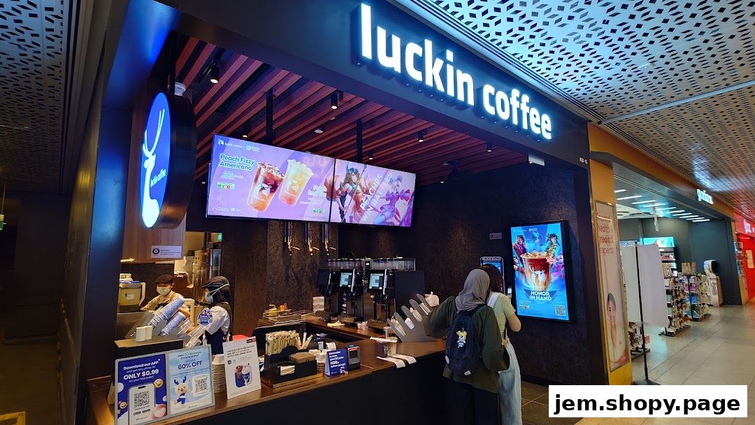 The Luckin Coffee shop front with illuminated signage and digital displays showcasing drinks.
