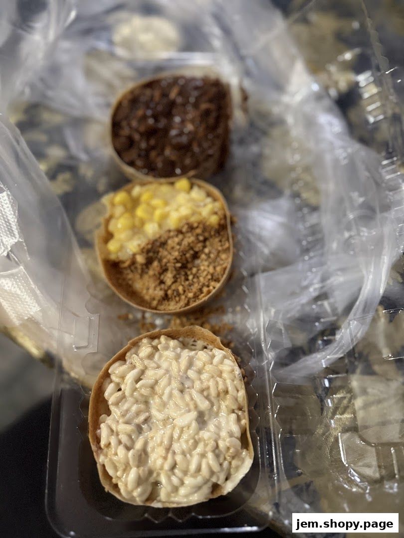 Three mini pancakes with various sweet toppings in a clear plastic container.