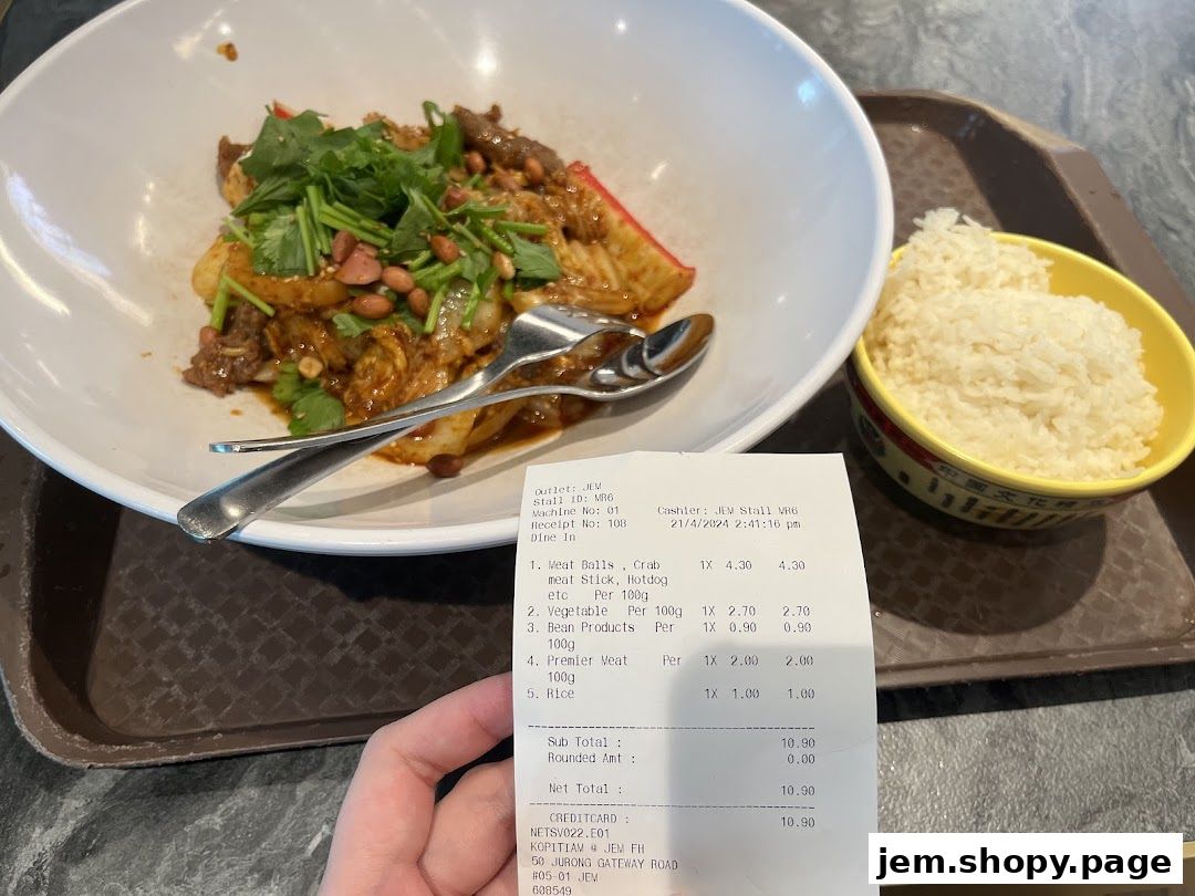 A plate of spicy mala stir-fry with rice and a receipt from Mala Version 2.