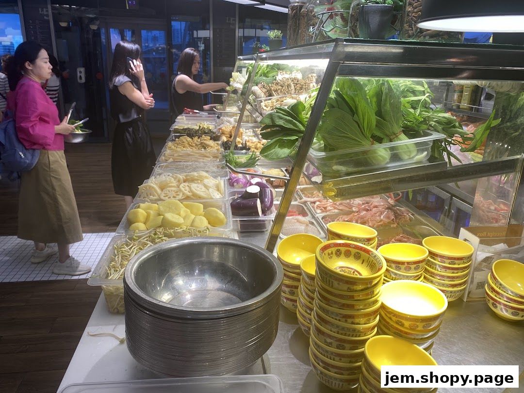 Customers select fresh ingredients from a display for a meal at Mala Version 2.