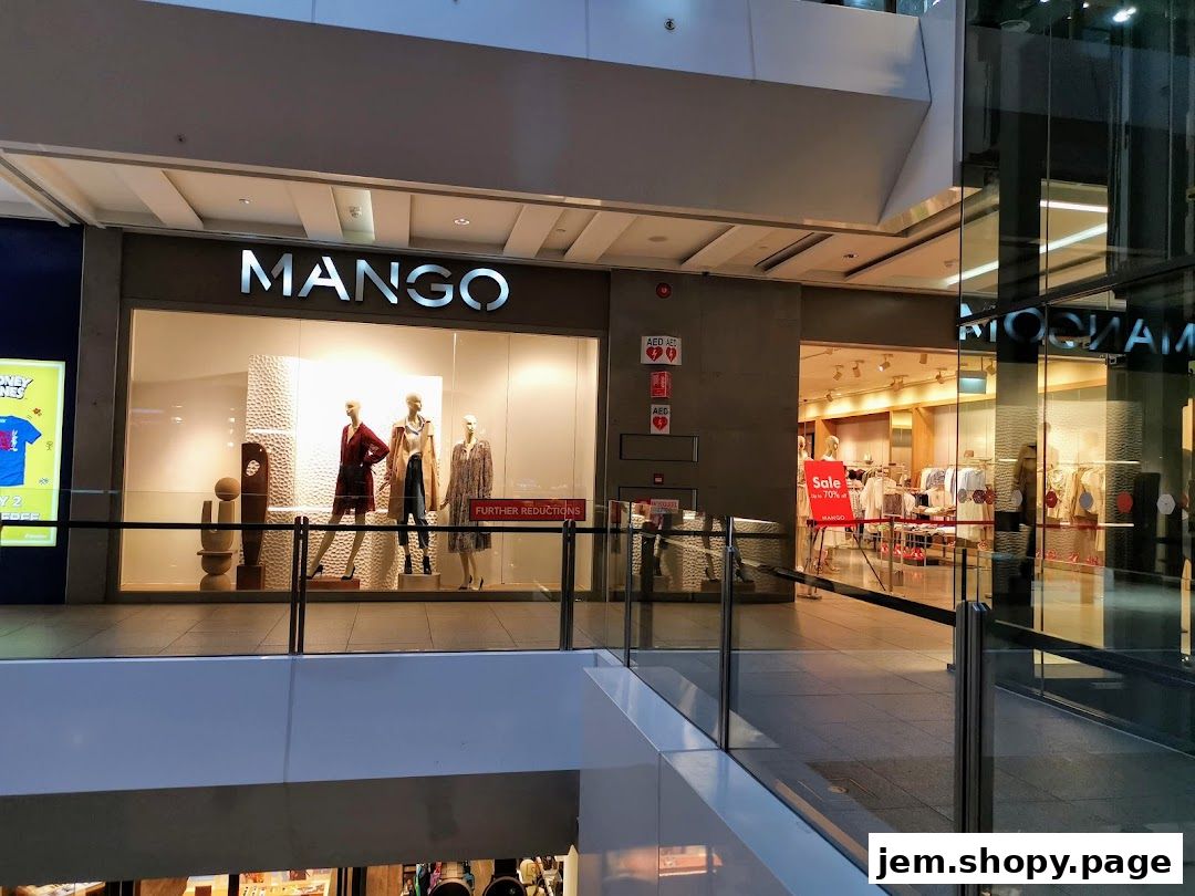The MANGO store entrance with mannequins displaying outfits and a sale sign.