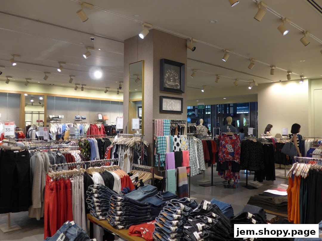 Interior view of a MANGO clothing store with racks of apparel and folded jeans.