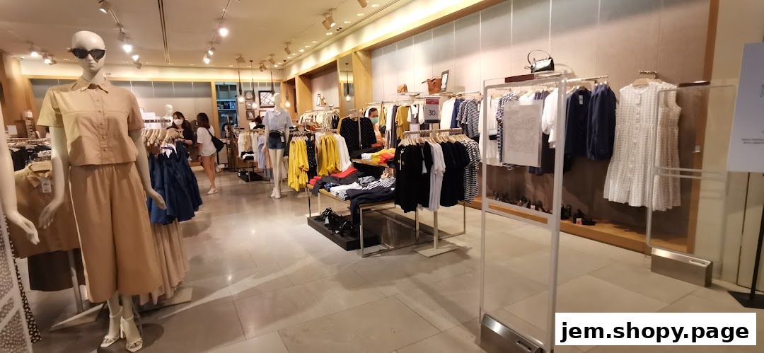 Interior view of a MANGO clothing store with mannequins and racks of apparel.