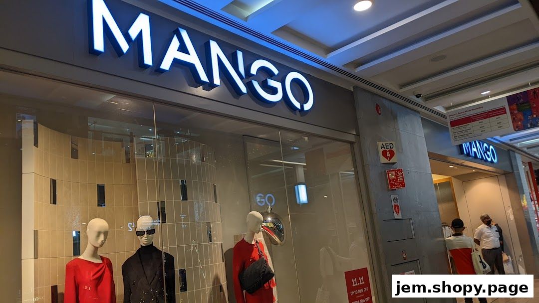 The exterior of a MANGO clothing store with mannequins in the window display.