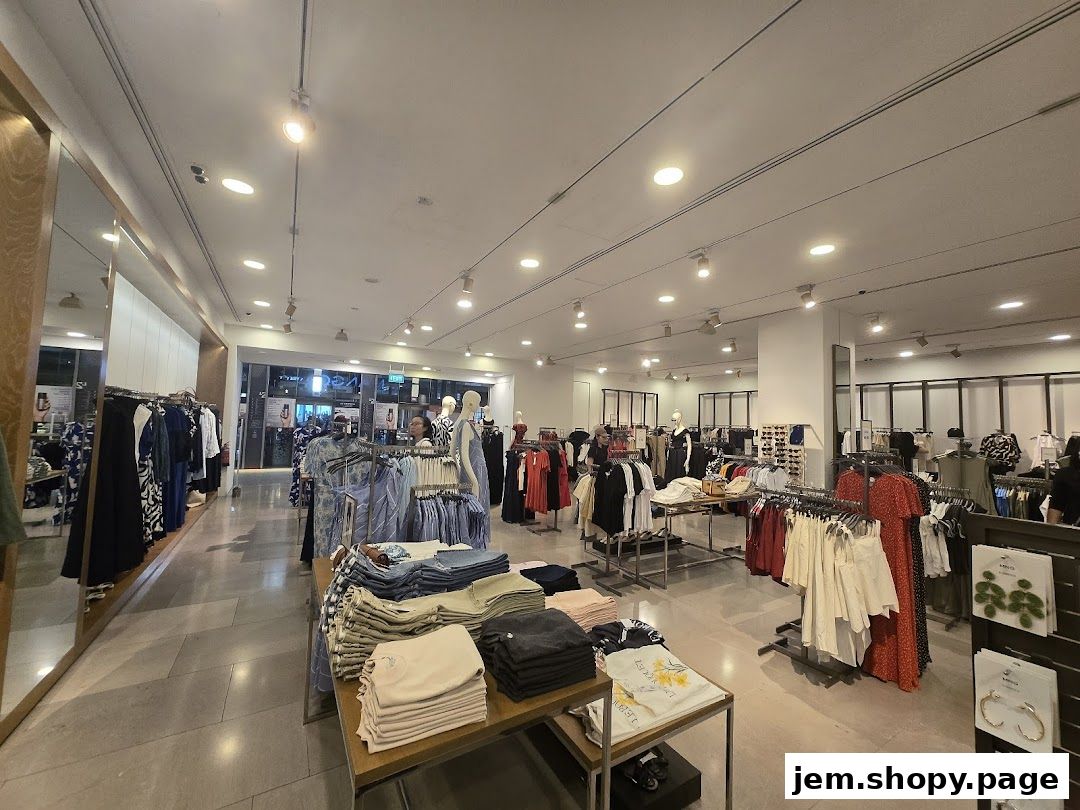 Interior view of a MANGO clothing store showcasing racks of apparel and mannequins.
