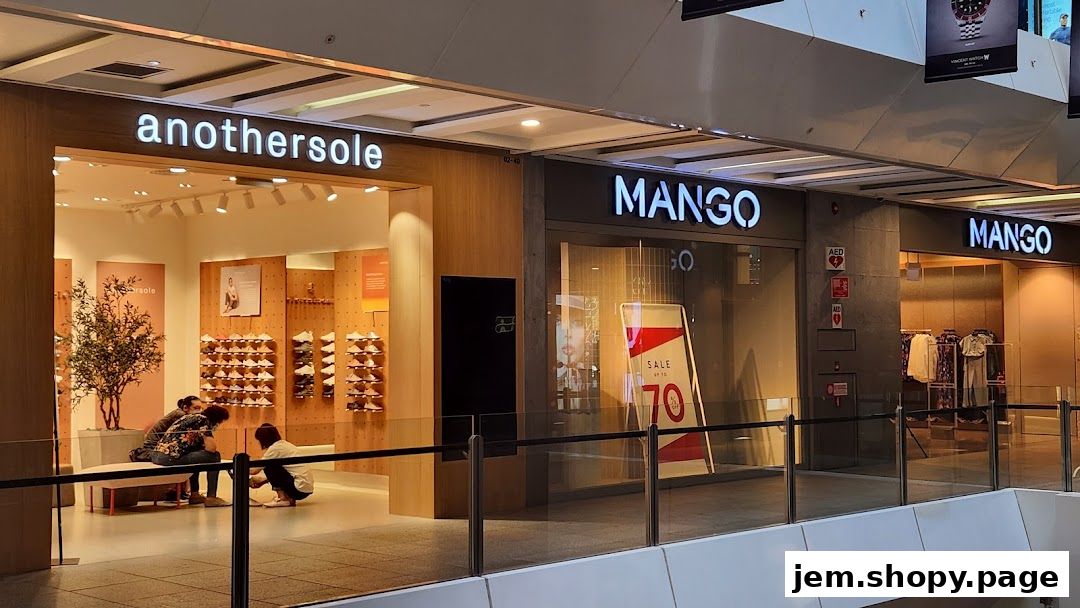 Exterior view of MANGO and anothersole shops in a mall, with a sale sign.