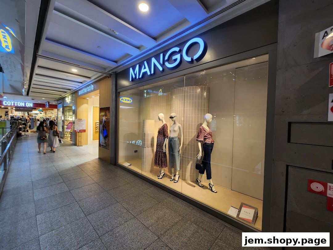 The exterior of a MANGO clothing store with mannequins displaying outfits in the window.