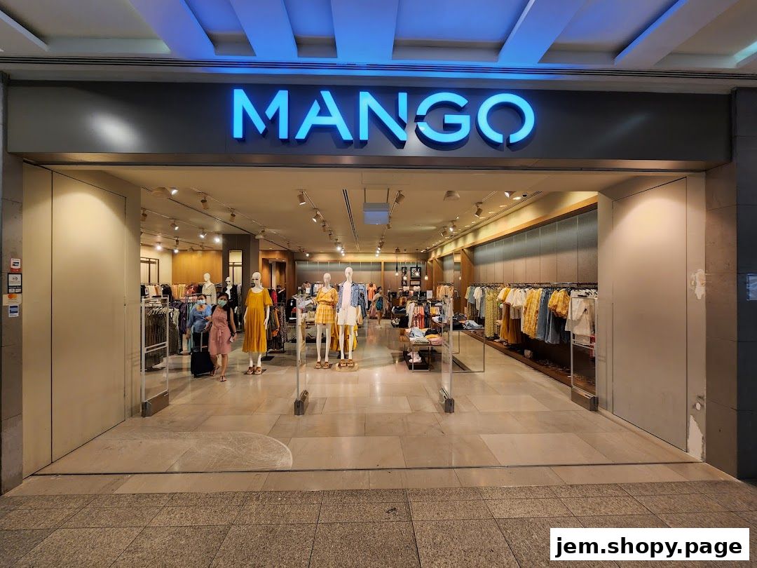 The entrance of a MANGO clothing store with mannequins and clothing displays visible inside.