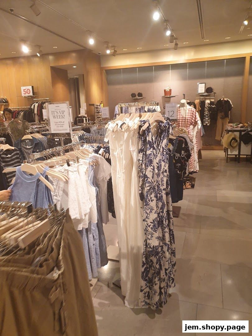 Interior view of a MANGO clothing store with racks of dresses and apparel.