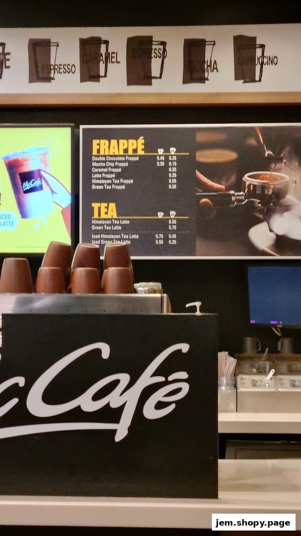 A McCafe menu board displaying Frappé and Tea options with prices.