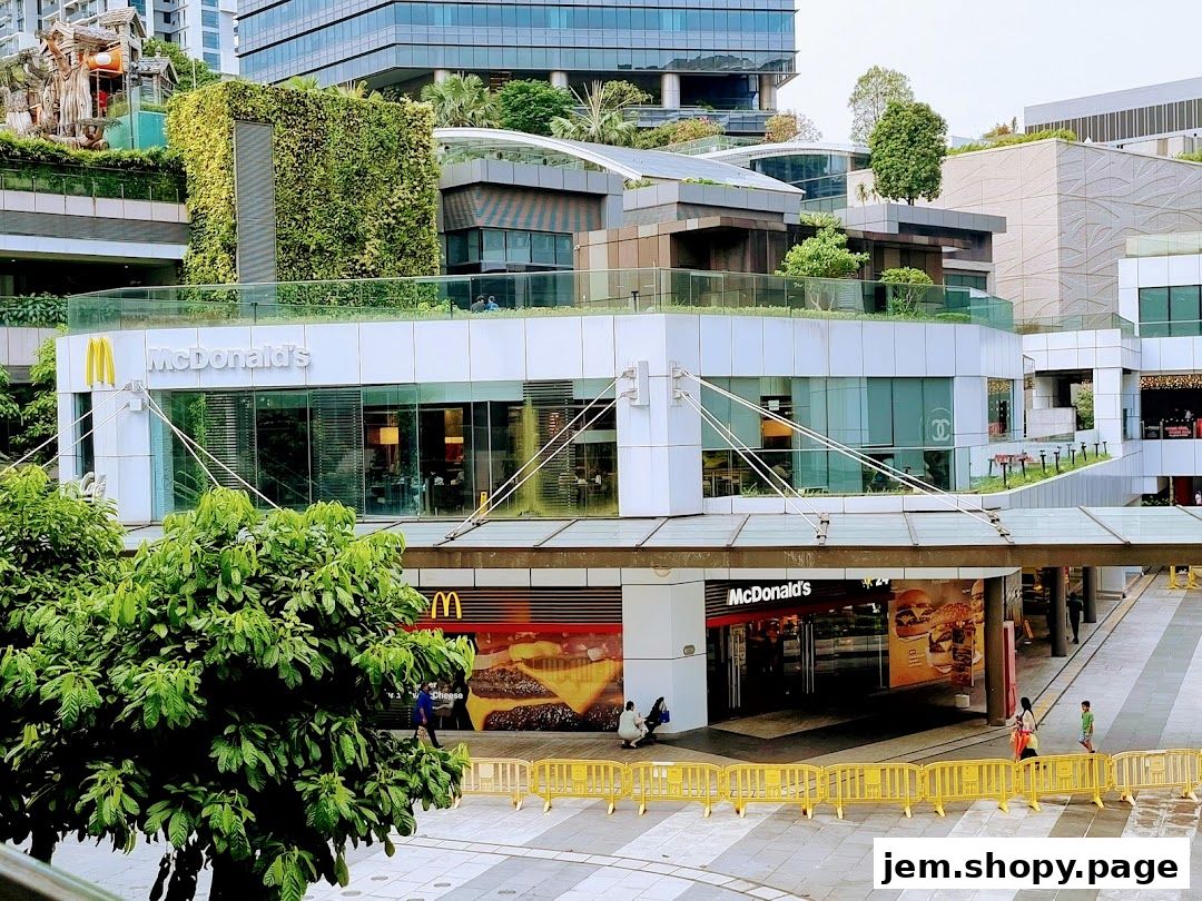 Exterior view of a McDonald's restaurant with its iconic signage and large burger advertisements.