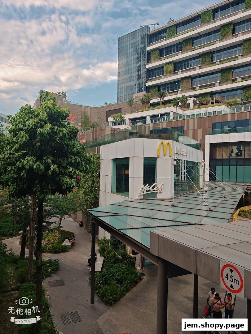 Exterior view of a McDonald's and McCafe with a modern architectural backdrop.