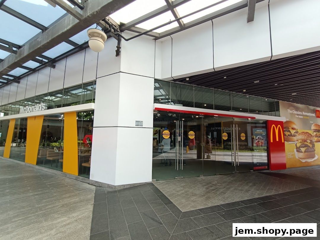 Exterior view of a McDonald's restaurant with large glass windows and prominent branding.