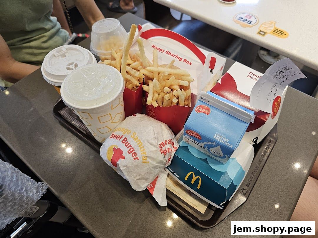 A tray of McDonald's food including burgers, fries, drinks, and milk.