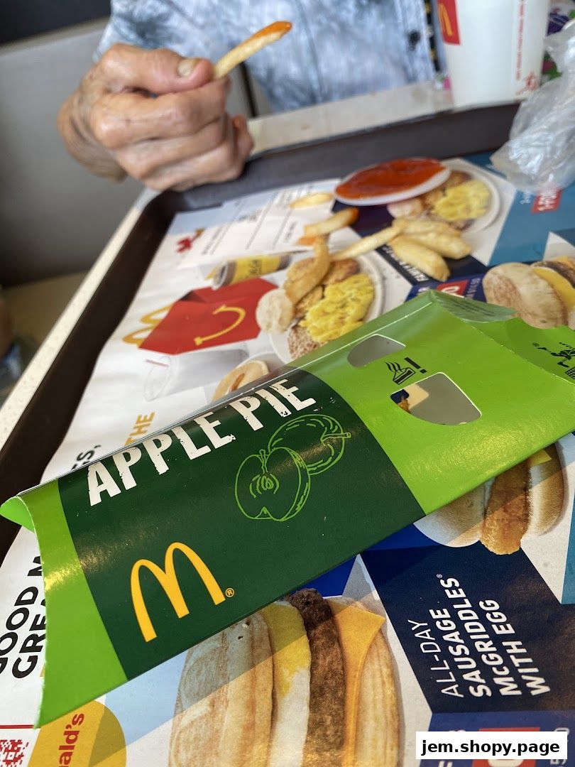 A tray of McDonald's food including fries, an apple pie box, and a drink.