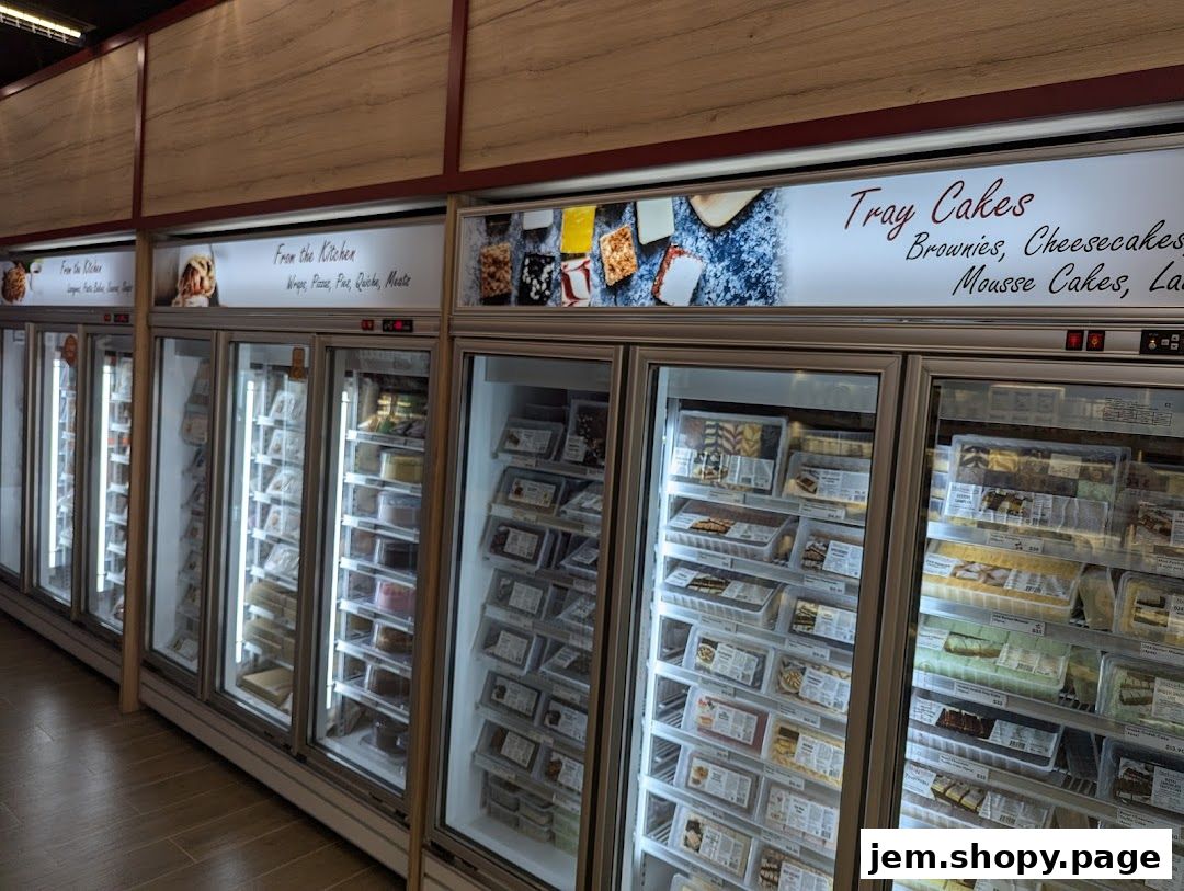 Refrigerated display cases filled with pre-packaged cakes, brownies, and other desserts.
