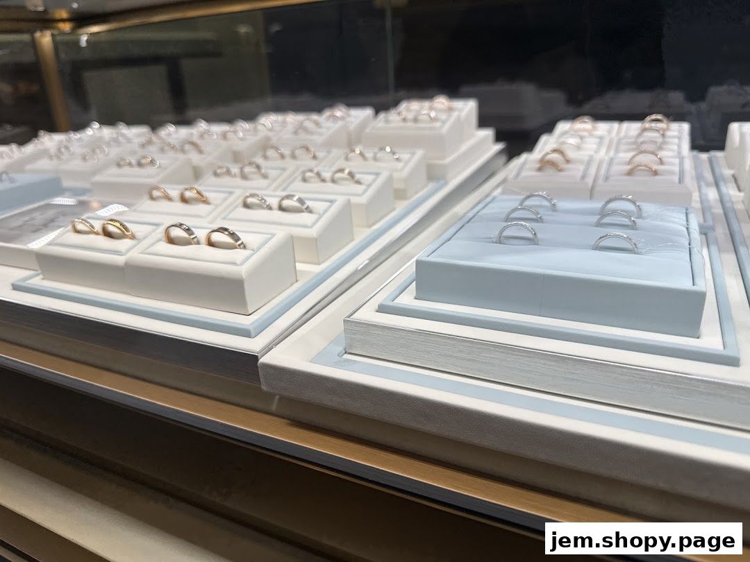 A display case filled with various rings, showcasing different styles and metals.