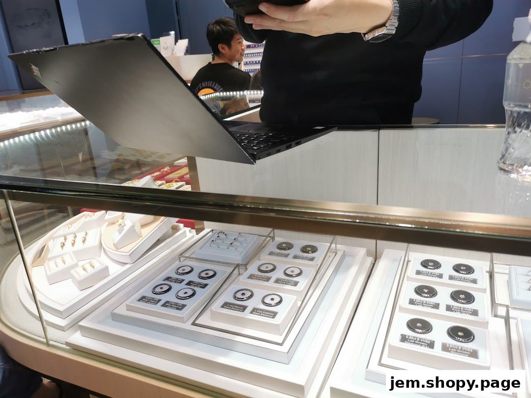 Jewelry display case with rings, earrings, and loose gemstones.
