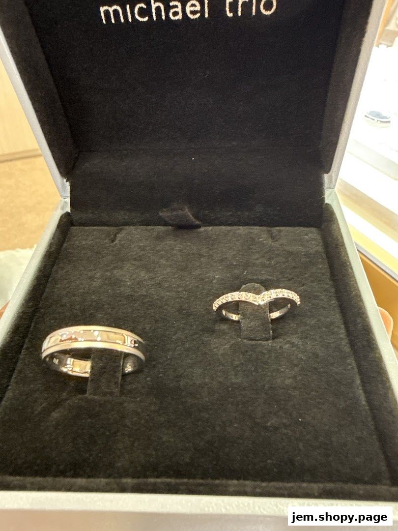 A jewelry box displaying two elegant rings, one with diamonds and another with subtle accents.