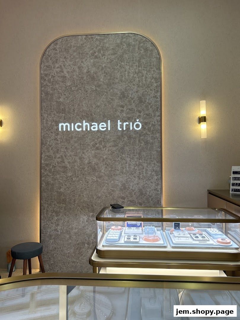 Interior of Michael Trio jewelry store with display cases and branded signage.
