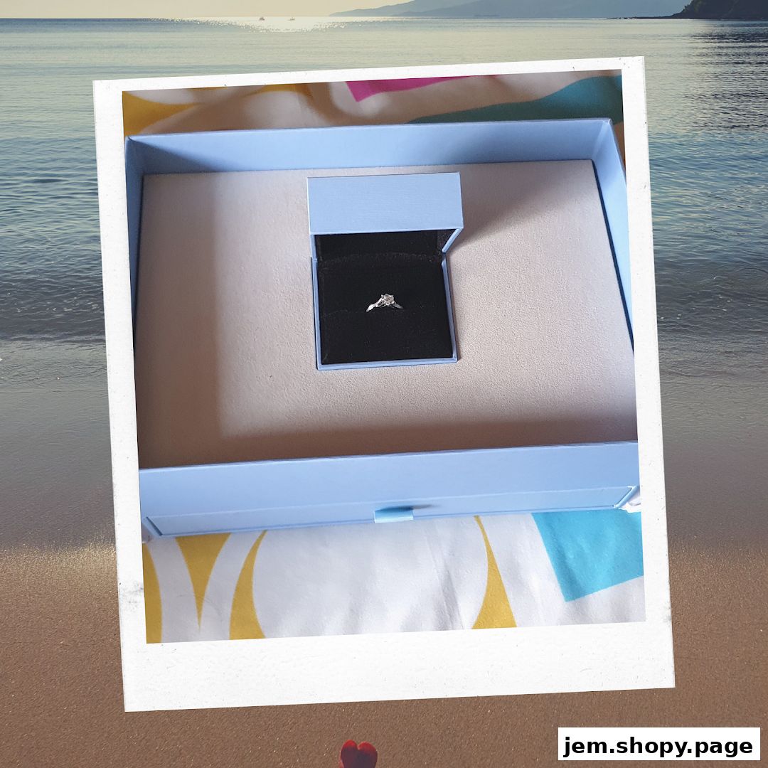 A diamond ring in a light blue box with a beach and ocean background.