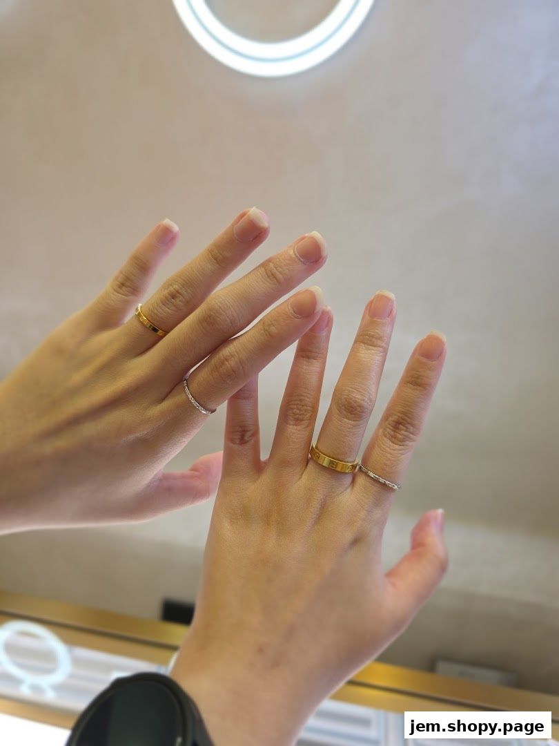 Hands adorned with elegant gold and diamond rings, showcasing fine jewelry.