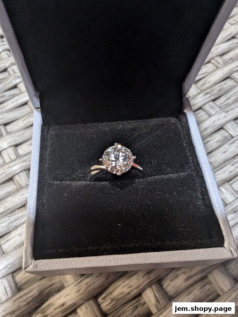 A sparkling diamond ring displayed in an open jewelry box.