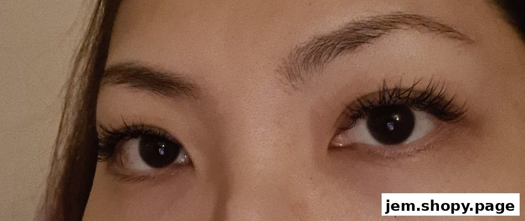 Close-up of a person's eyes with dramatic false eyelashes and well-defined eyebrows.