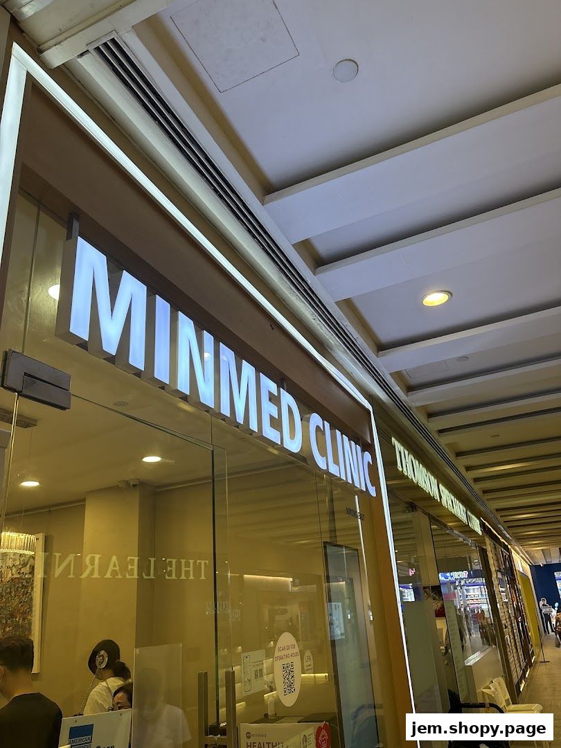 The exterior of Minmed Clinic Jurong East with illuminated signage and glass doors.