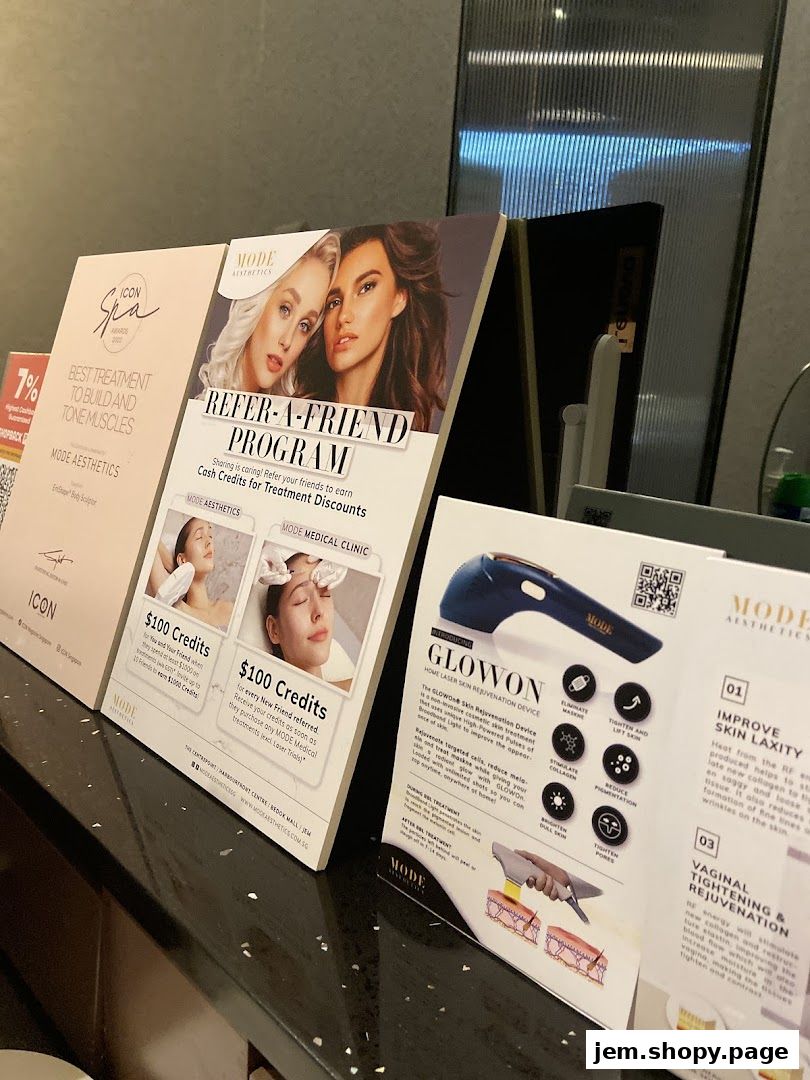 Brochures and flyers for aesthetic treatments and a referral program are displayed on a counter.