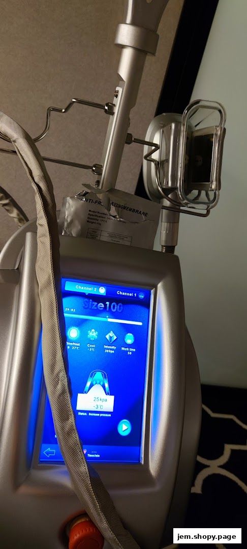 Close-up of a cryolipolysis machine with a blue digital display showing treatment parameters.