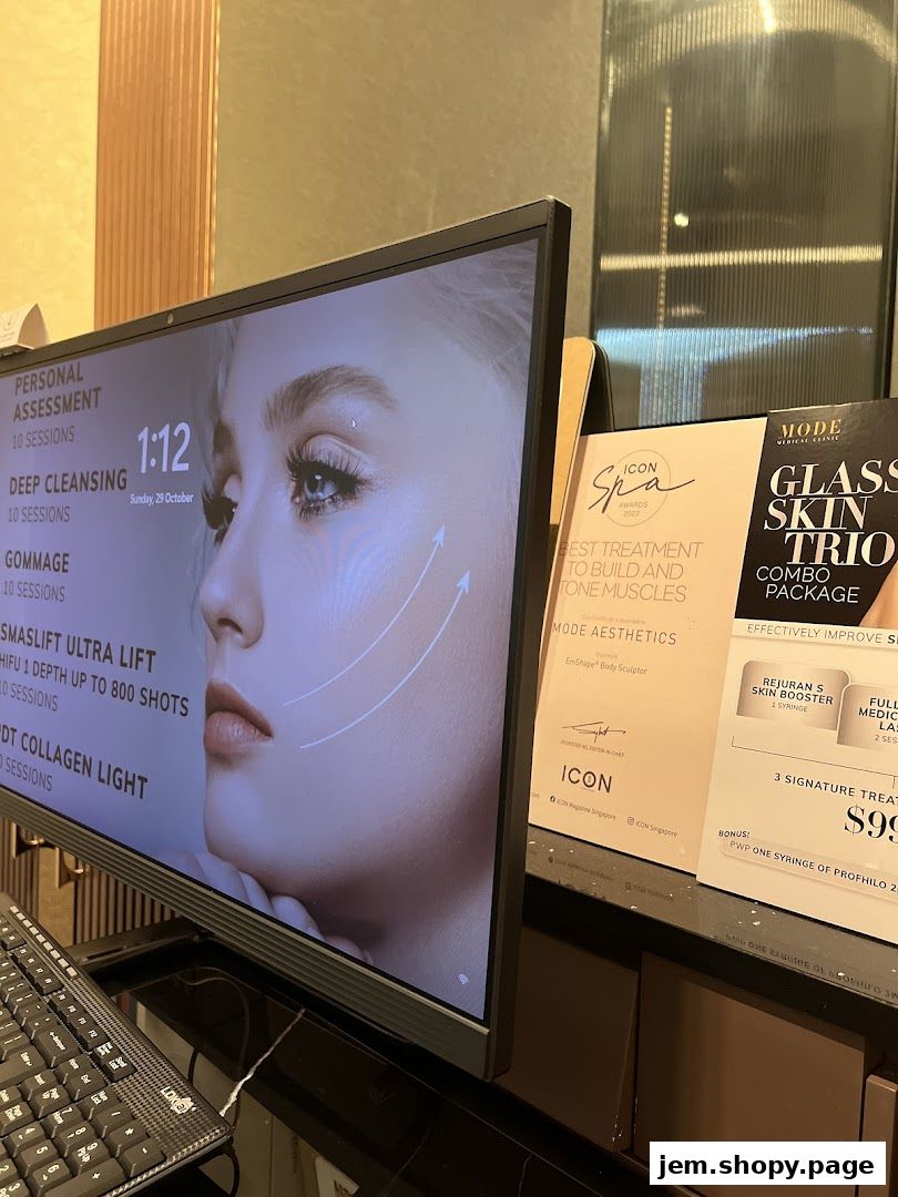 A computer screen displays aesthetic treatments next to promotional brochures for MODE Aesthetics.