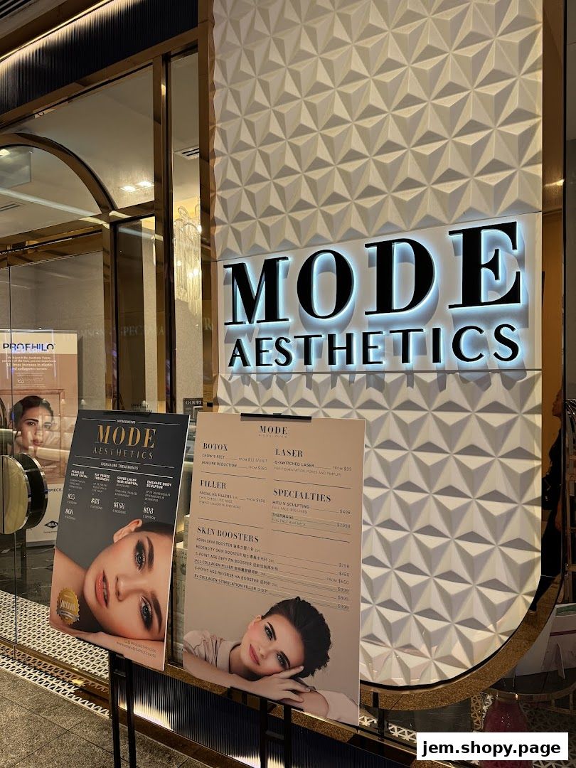 Exterior view of MODE Aesthetics with a prominent sign and displayed service menus.