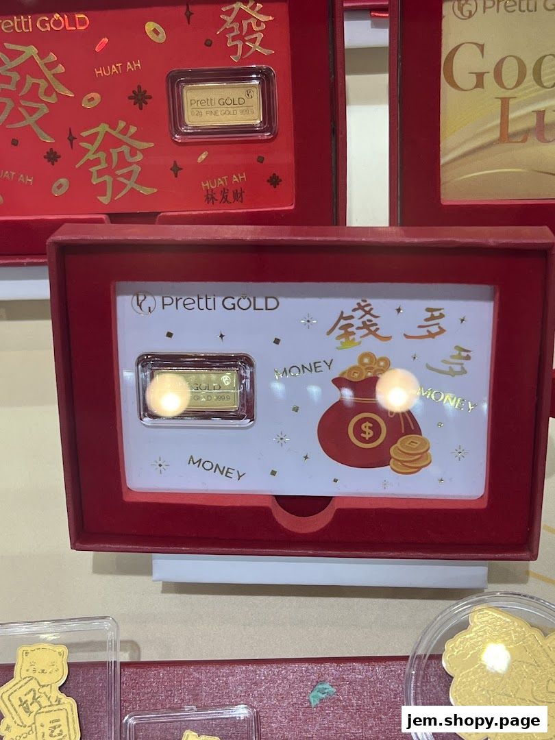 Display of small gold bars and coins with Chinese New Year themed packaging.