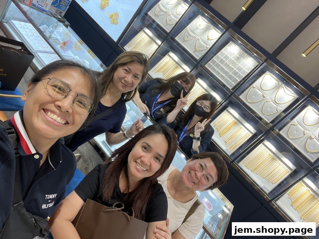 A group of smiling women pose for a selfie inside a jewelry store.
