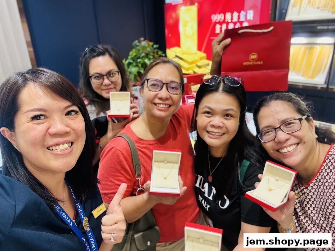 A group of women smiling and holding jewelry boxes from MoneyMax Pawnshop.