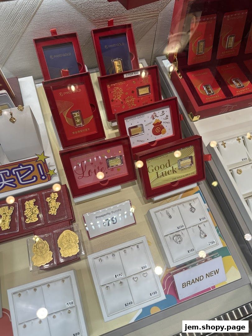 Display case showcasing gold bars, jewelry, and prosperity bundles with prices.