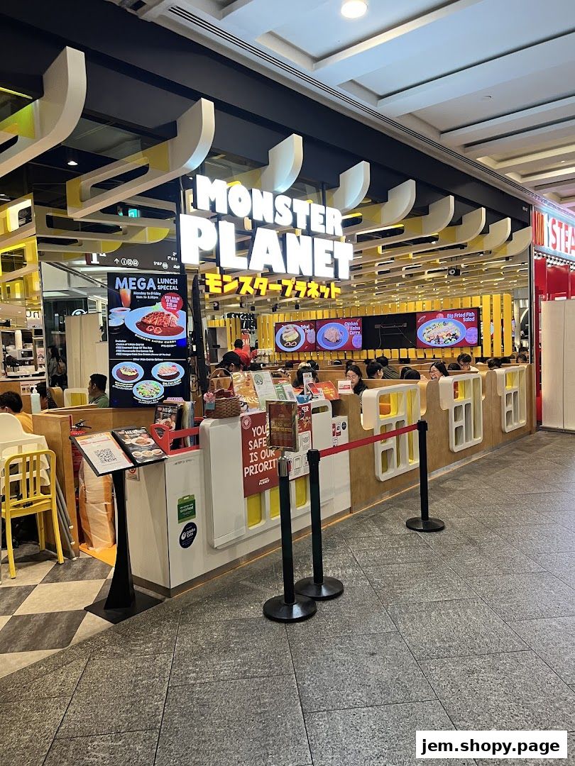 The exterior of Monster Planet restaurant with its prominent signage and displayed menu items.