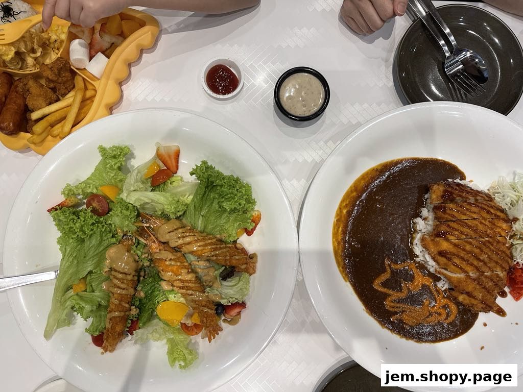 A table with various dishes including a salad, curry rice, and a kids' meal.