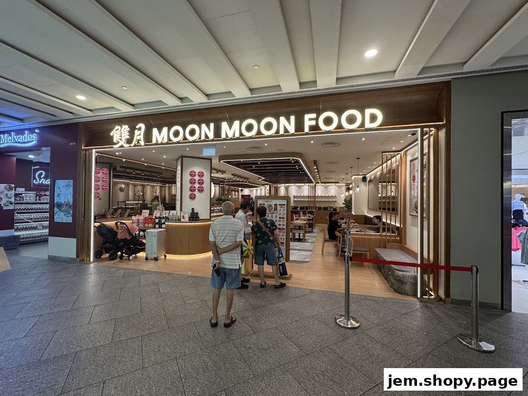 The exterior of Moon Moon Food, a modern eatery with a warm wooden interior and illuminated signage.